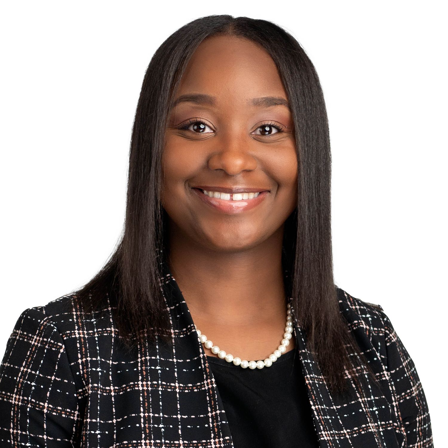 Professional headshot with person wearing black tweed blazer and pearl necklace.