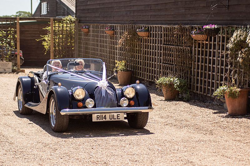 father of the bride and bride in antique car