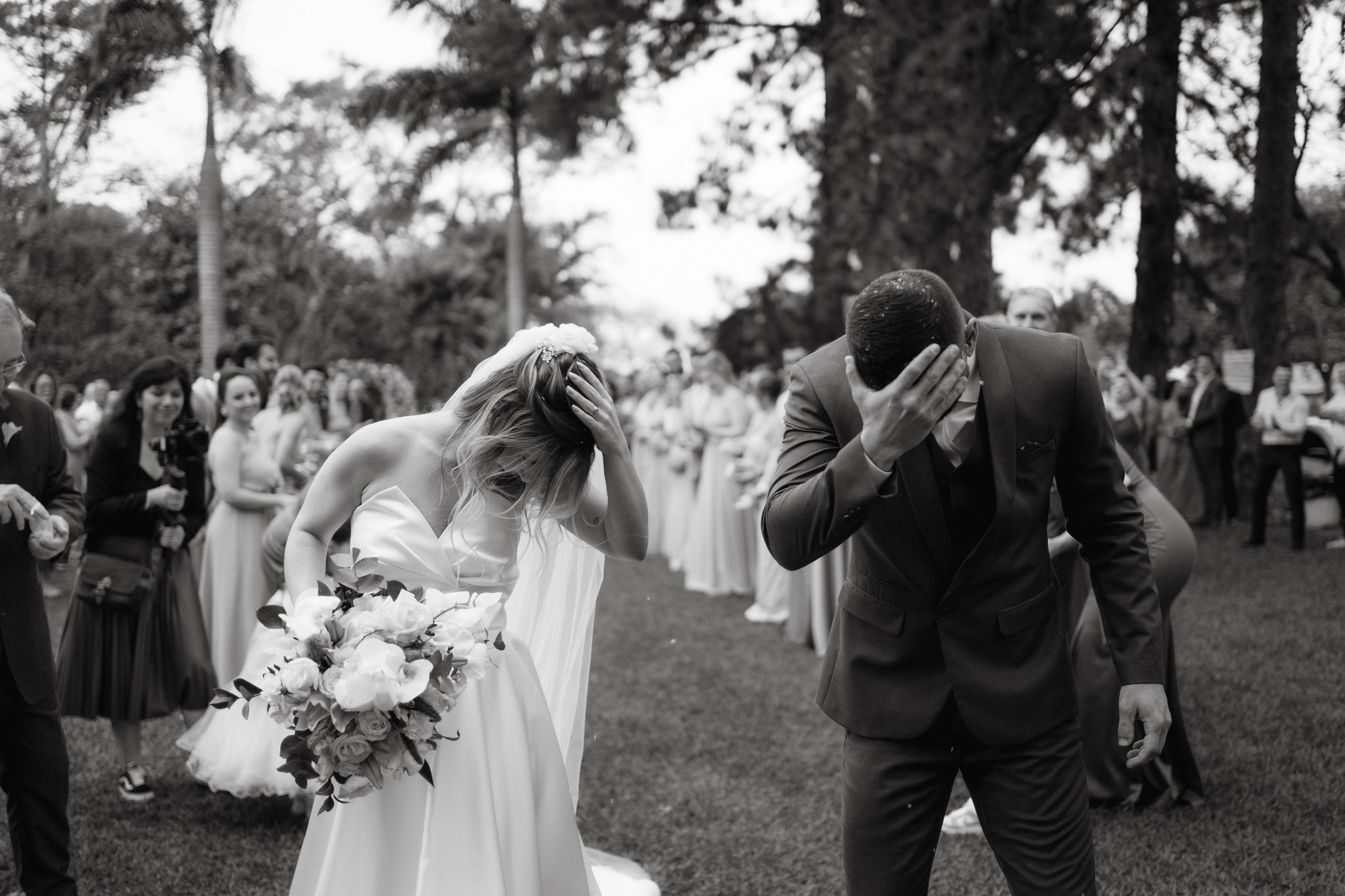 Black and white photo of emotional couple sharing a moment during their outdoor wedding ceremony.
