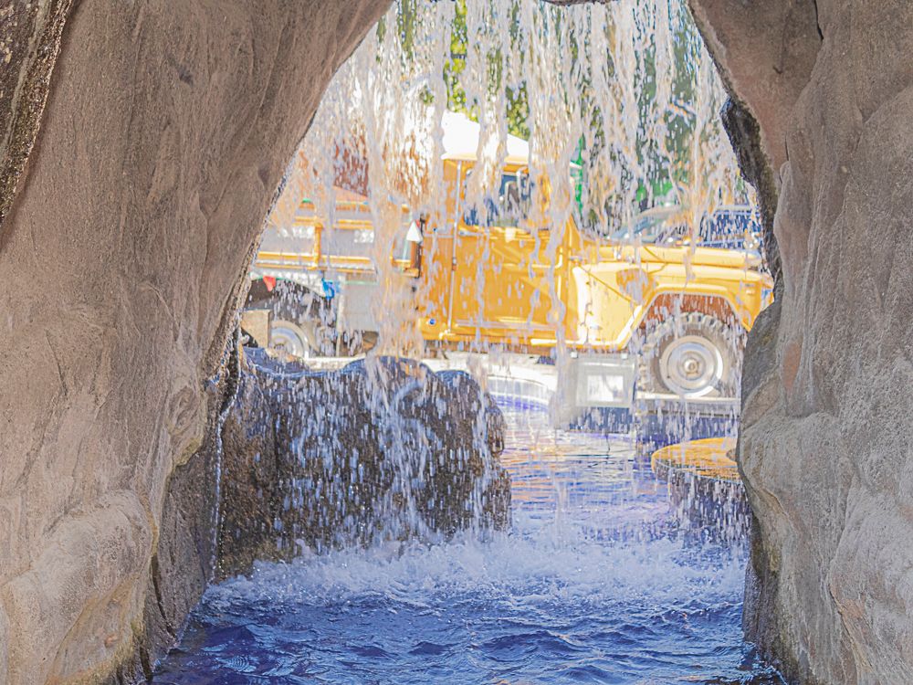 Water flowing through stone tunnel with sunlight beyond, photographed by Piret Victoria Ribas.