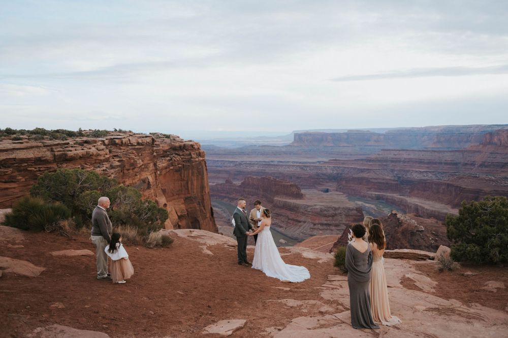 An elopement wedding ceremony near a stunning overlook in Dead Horse State Park Utah.