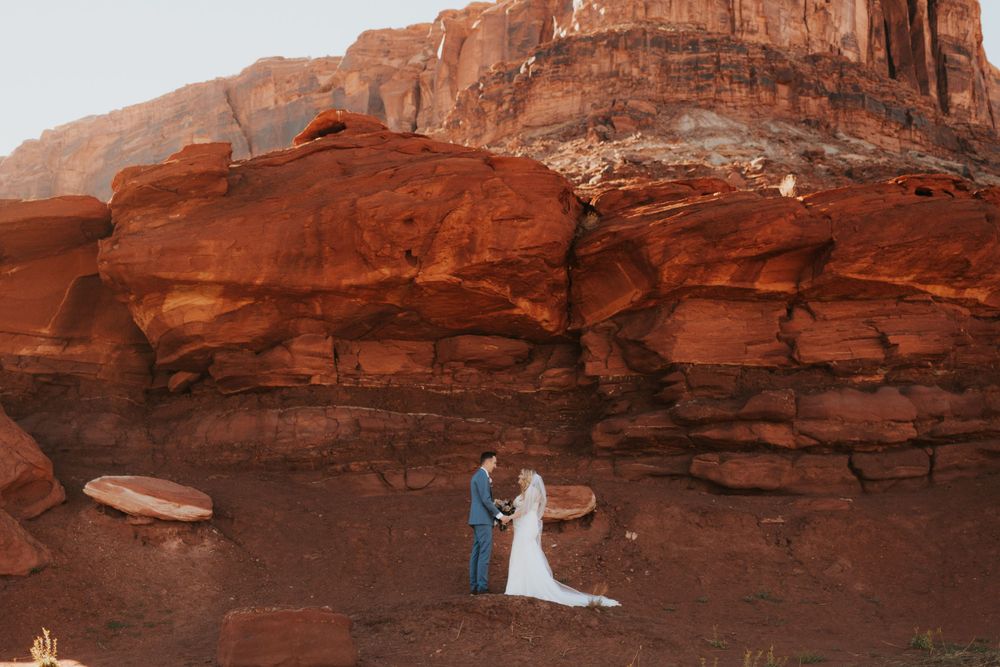 A couple celebrates during their destination elopement in Moab, Utah. Captured a luxury elopement photographer.