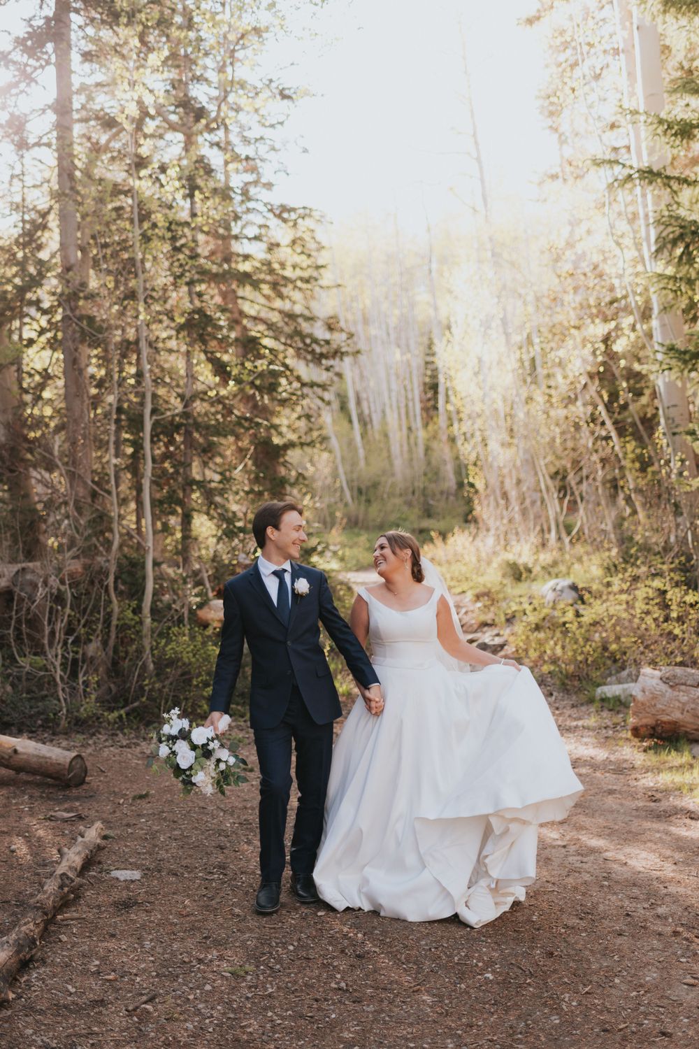 A couple smiles at each other during their destination elopement in the mountains of Salt Lake City, Utah.