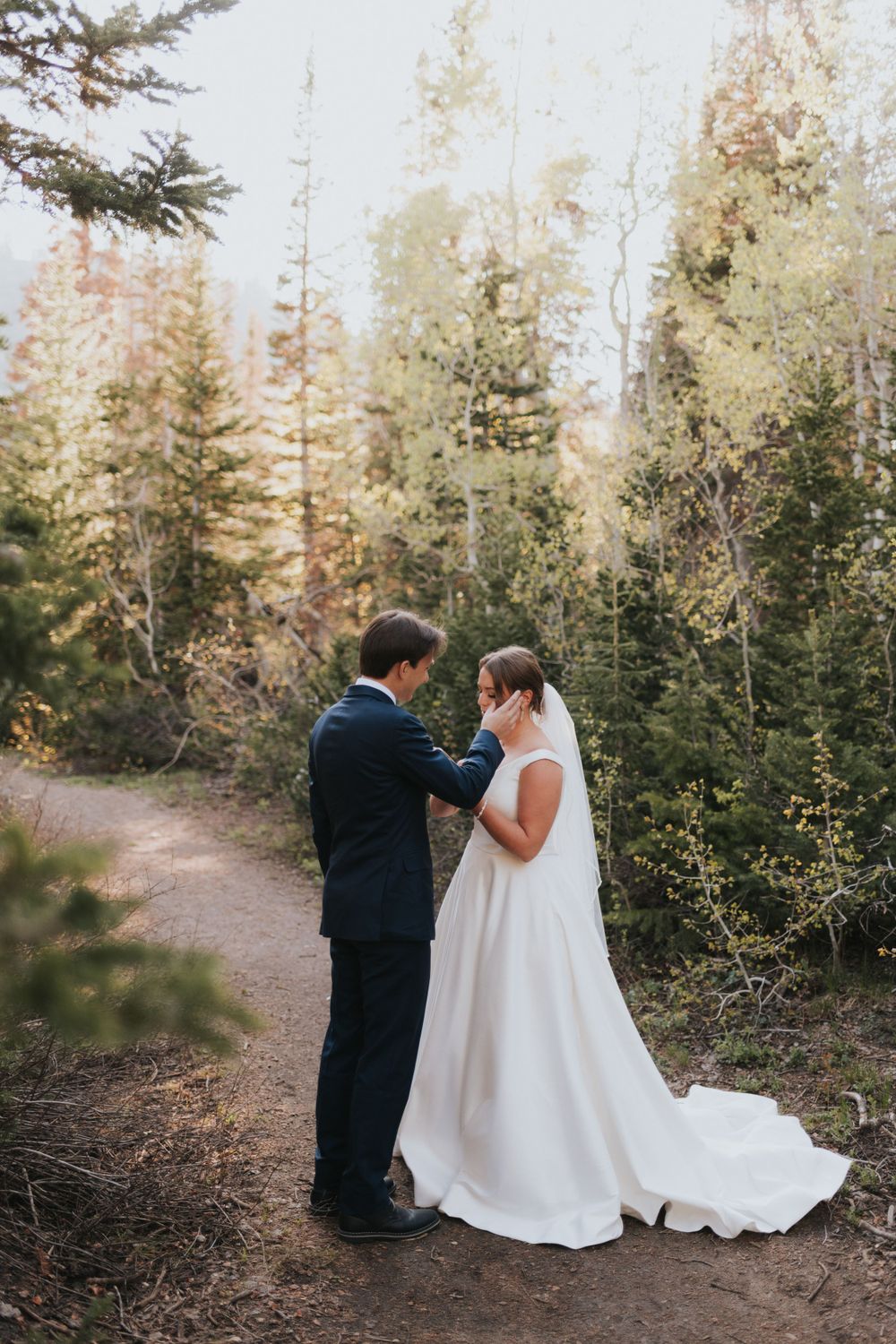 A couple shares a tender moment during an intimate summer elopement near Park City, Utah.