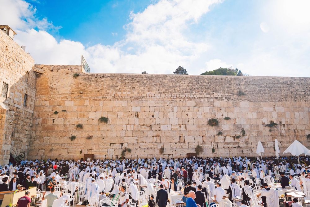 western wall of jerusalem full of religious pilgrims