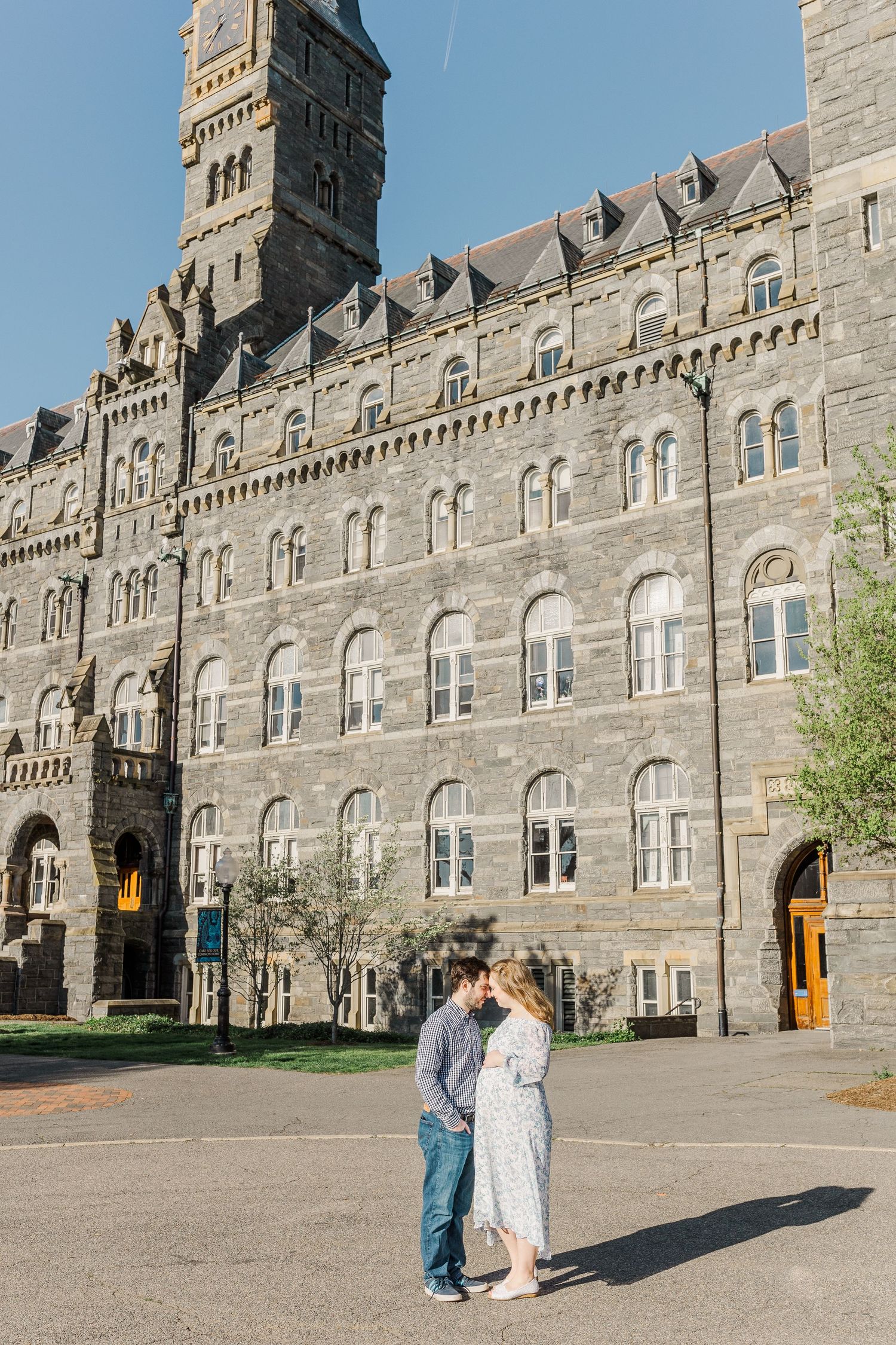A Gothic stone castle building with ornate architecture and arched windows stands majestically.
