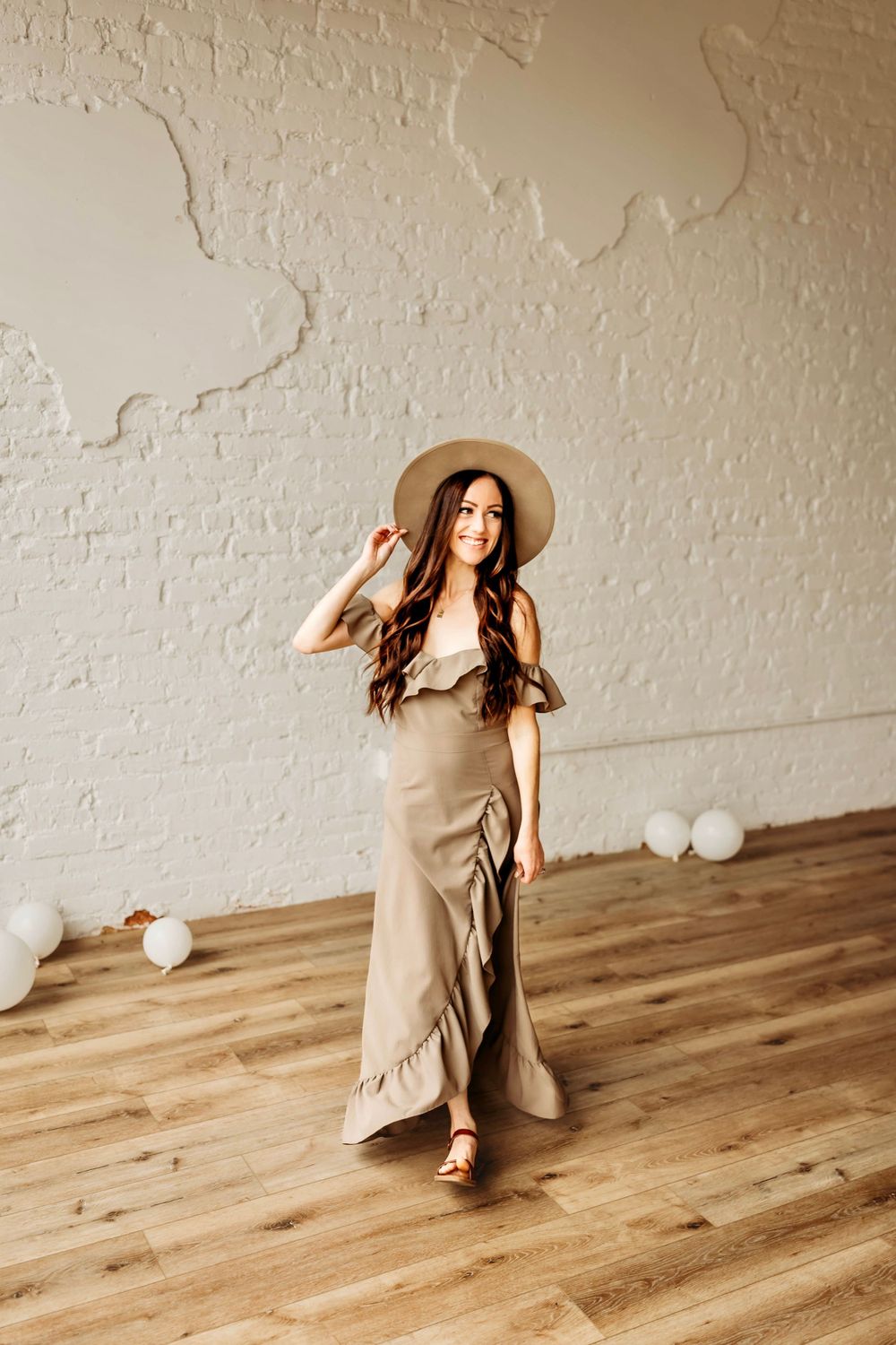 North Haven photographer posing in studio with hat and client wardrobe