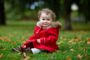 little girl sitting on the ground