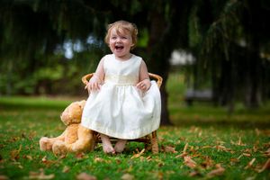 little girl sitting on the ground