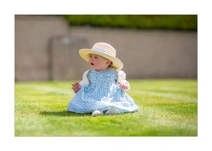 little girl sitting on the ground