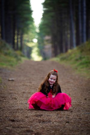 little girl sitting on the ground