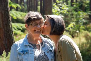 mother getting a kiss from a loving daughter