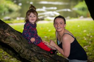 mum and daughter having fun on a tree