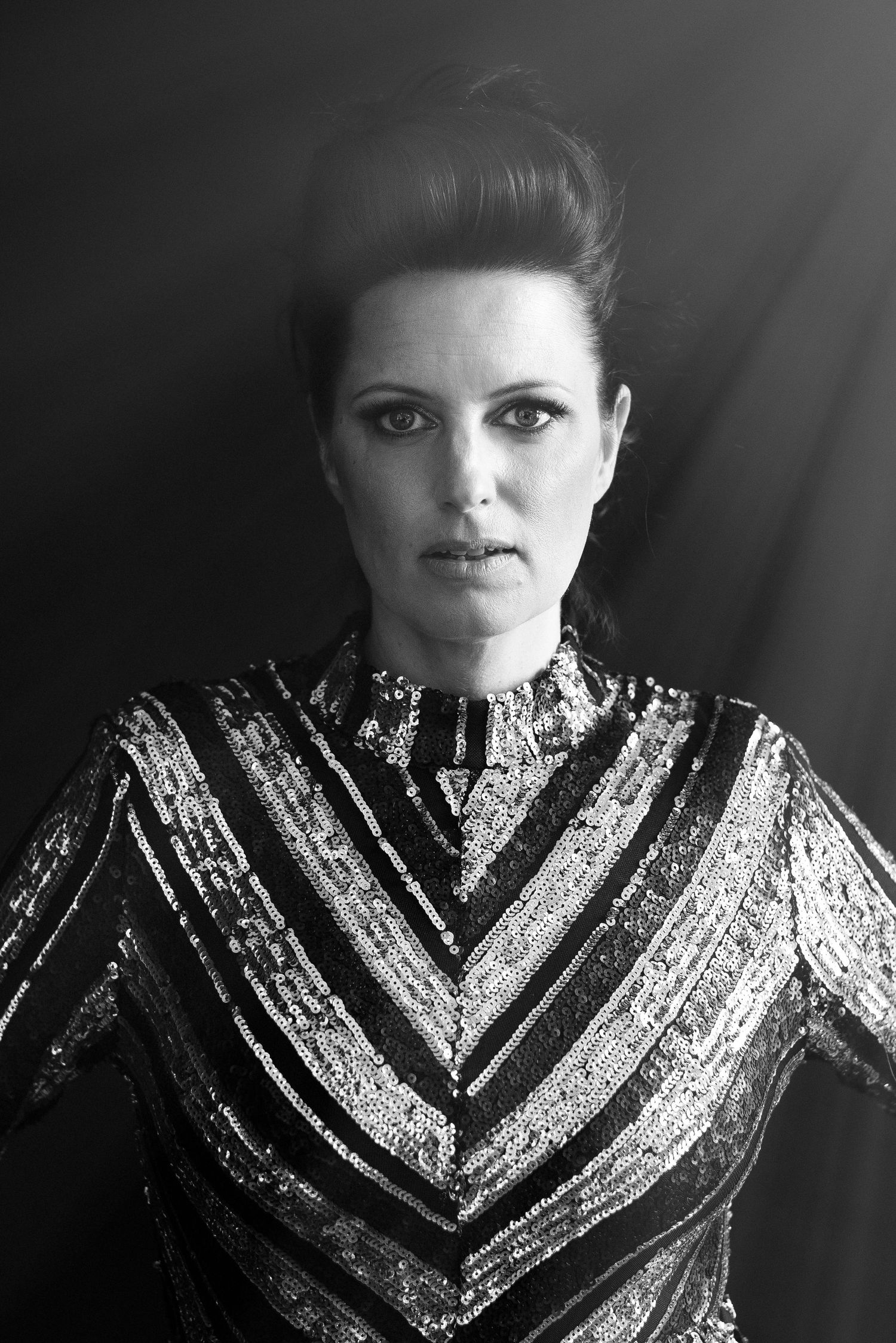 Dramatic black and white portrait in chevron sequined high-neck dress.