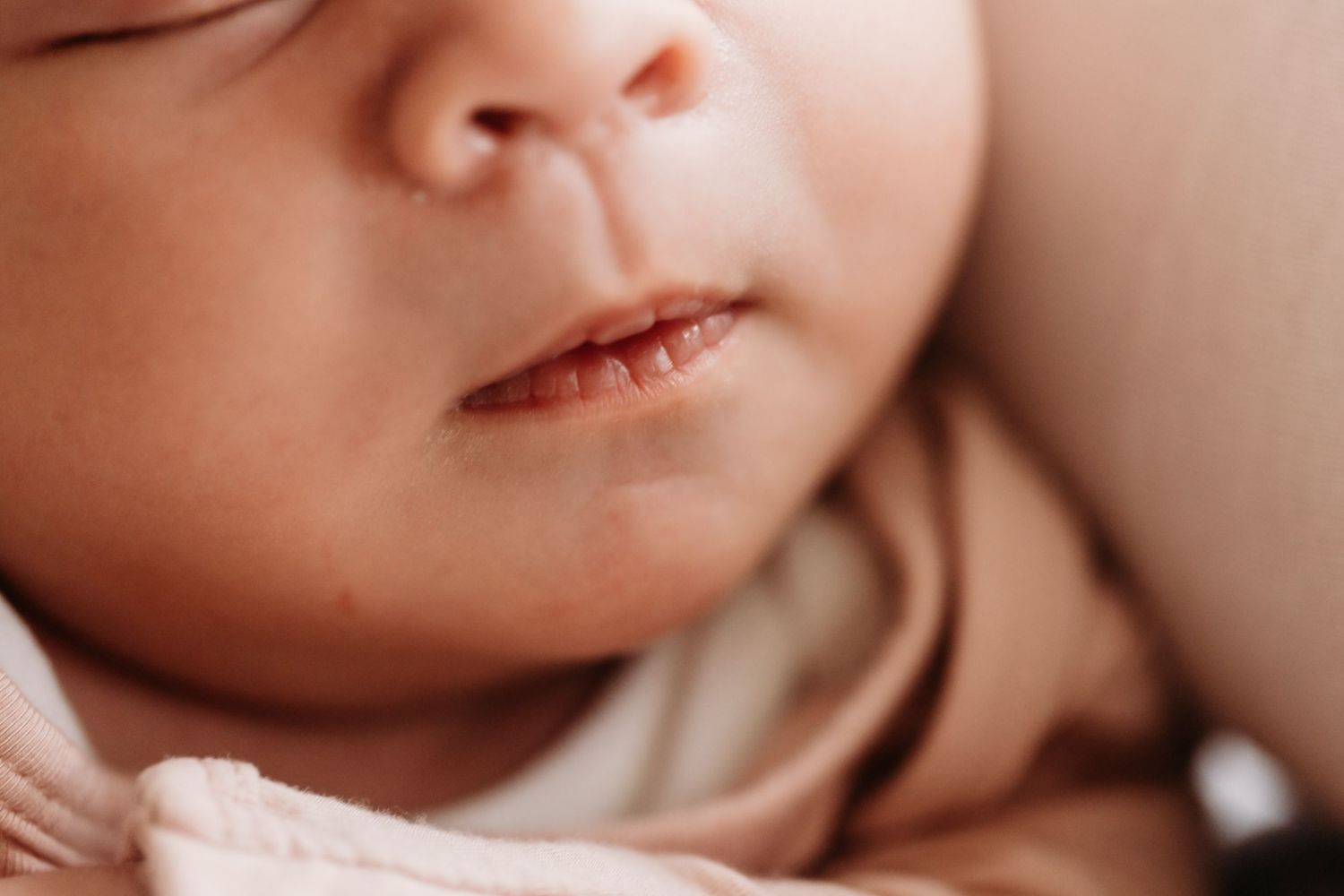 Extreme close-up shot of a sleeping baby's face and lips.