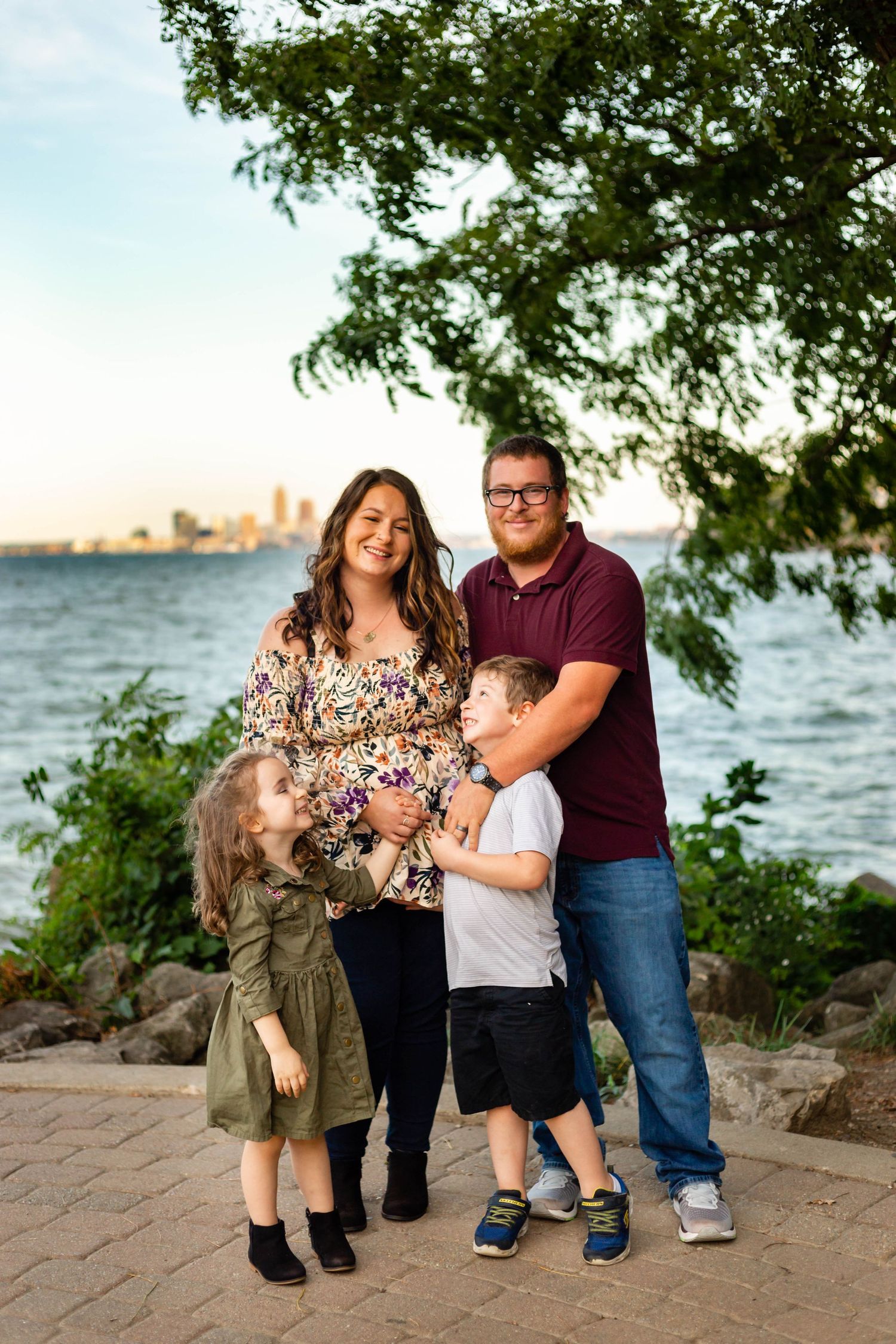 a family posing with the cleveland skyline