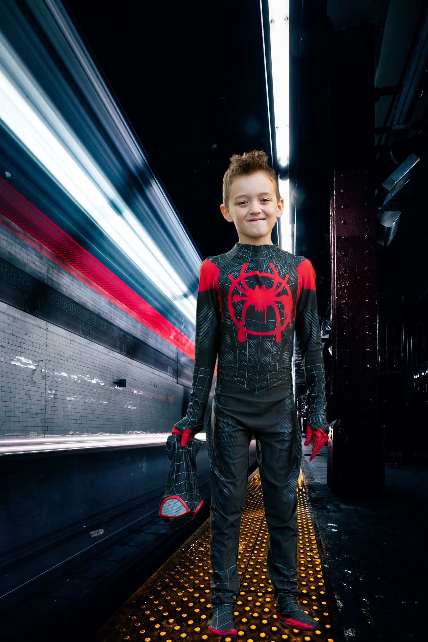 A dark corridor with fluorescent lighting and yellow textured floor features a figure in Spider-Man themed clothing.