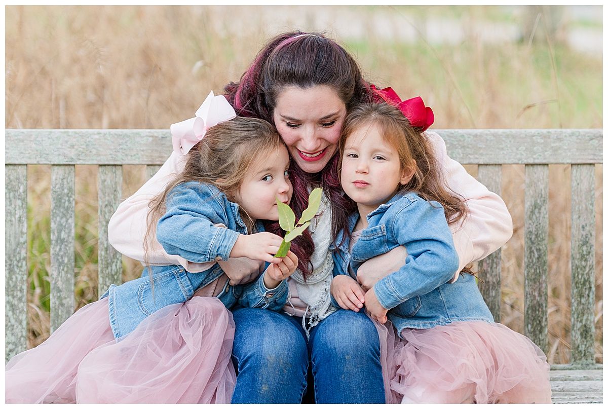 Family Photographer captures mother hugging twin daughters in photography session at Holliday Park Indianapolis Indiana