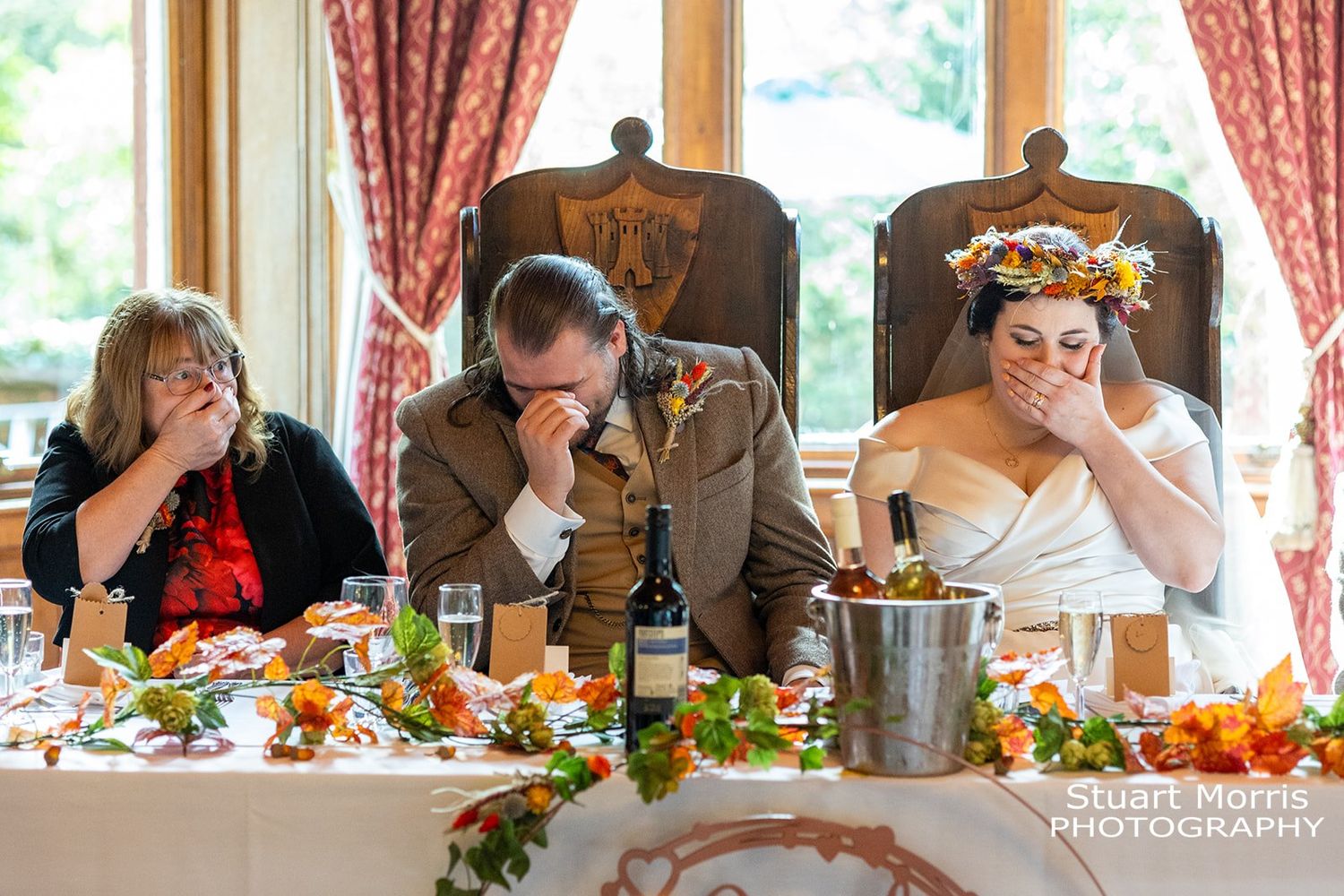 bride laughing, groom head in hands, brides mum hand over her mouth during the wedding speeches. ruthin castle wedding