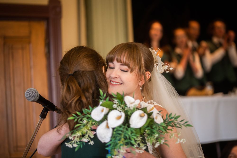 wedding ceremony bride and groom hug close up acton town hall interior