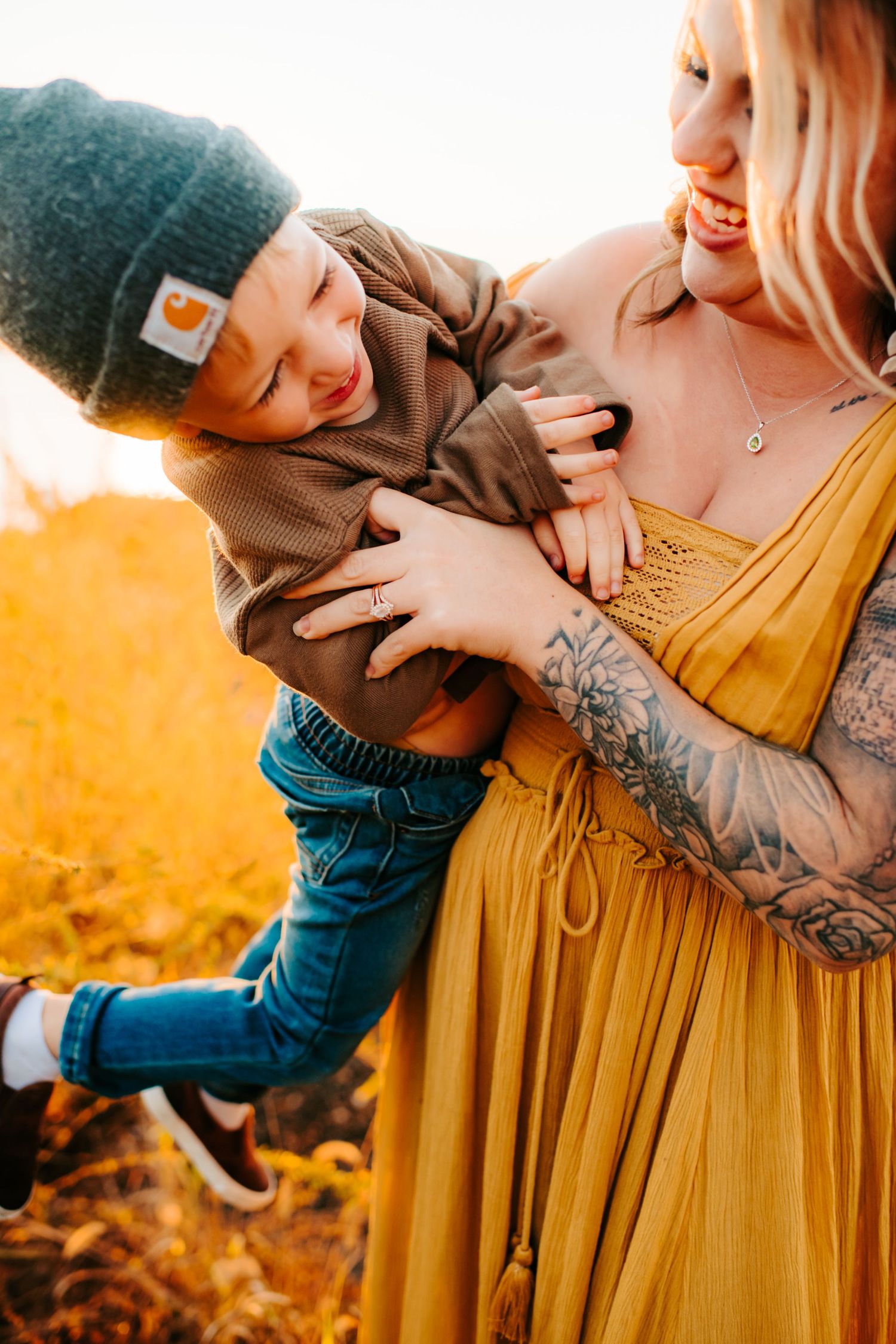 A playful lifestyle moment captured in golden light with a mustard dress and warm autumn tones.
