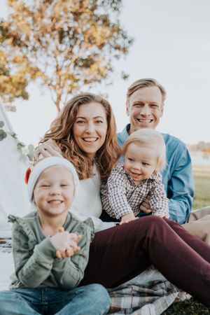 Family laughing together during a casual outdoor photo session.