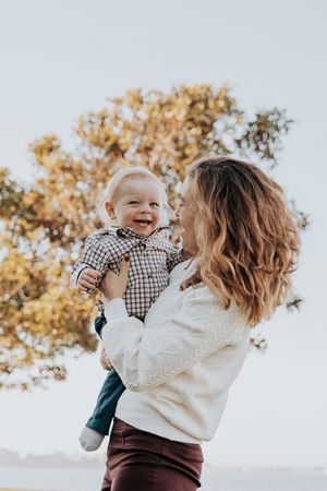 Candid moments of joy and laughter during an outdoor family photoshoot.