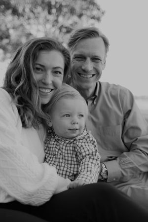 Black and white portrait of a family sharing intimate moments together.