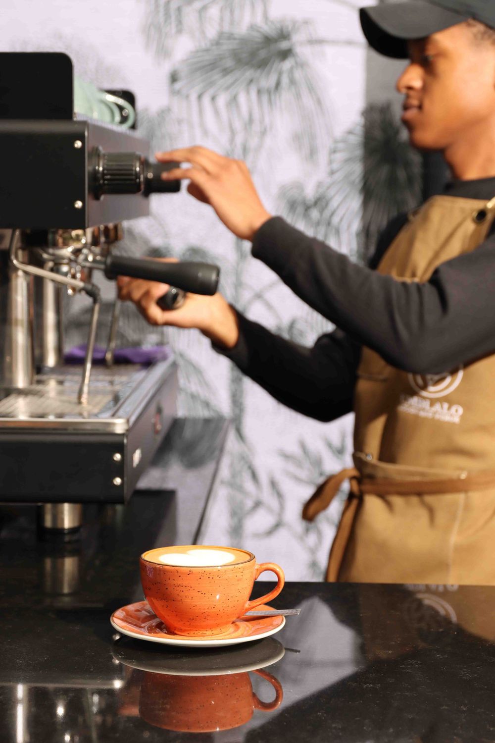 Barista preparing coffee in café