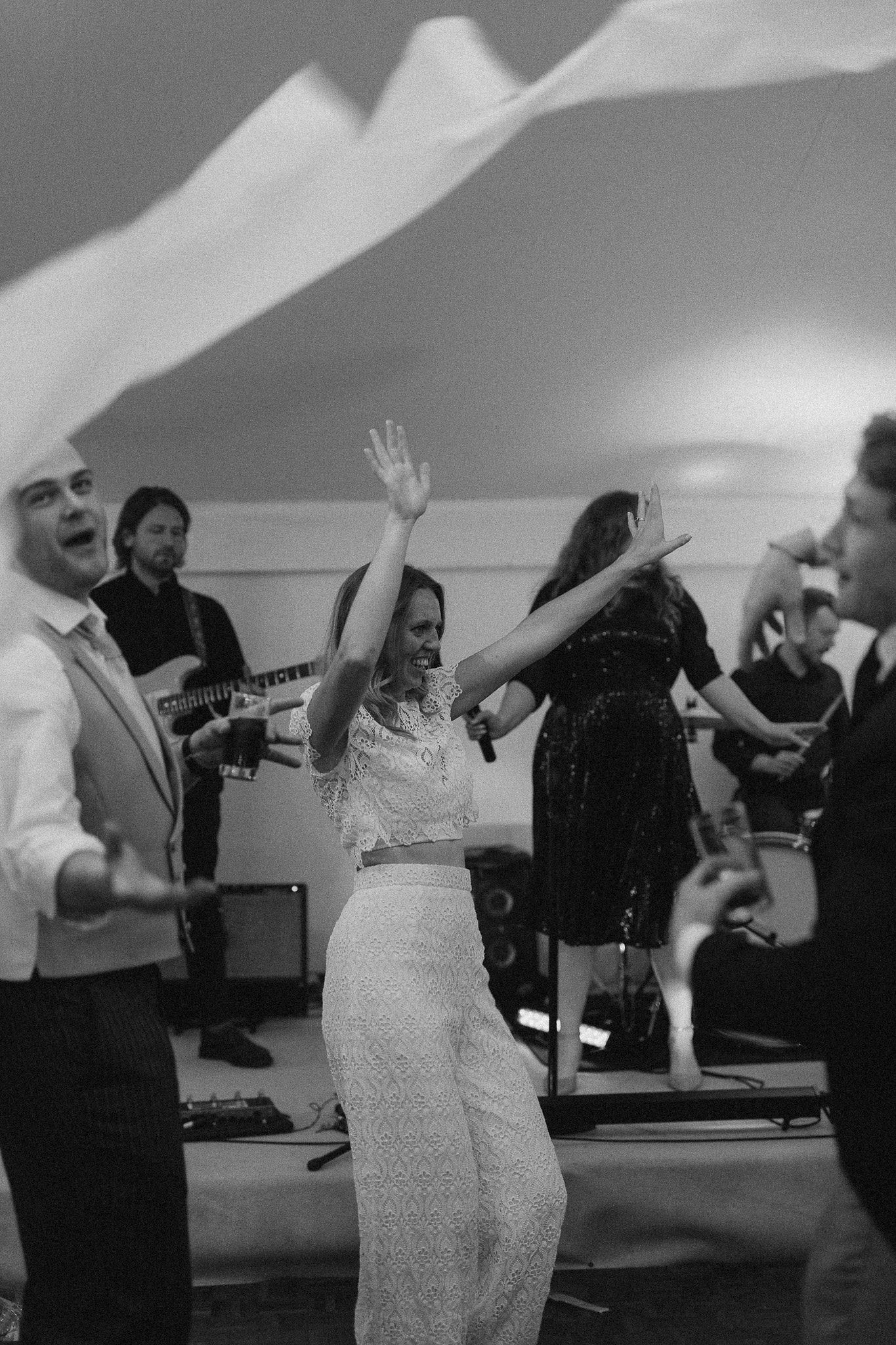 Documentary-style wedding photography of the bride dancing during the evening celebrations