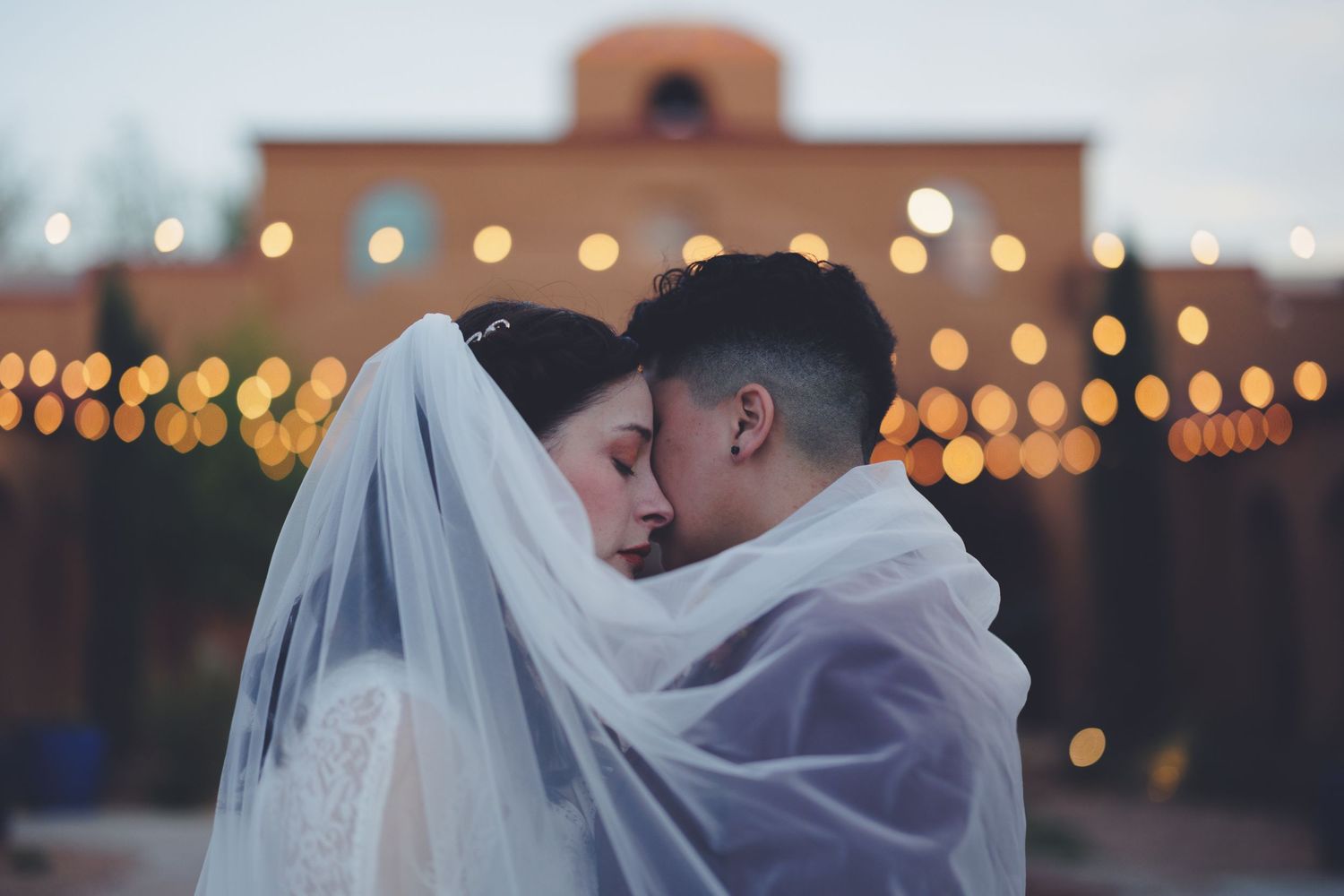 Brides embracing each other at twilight
