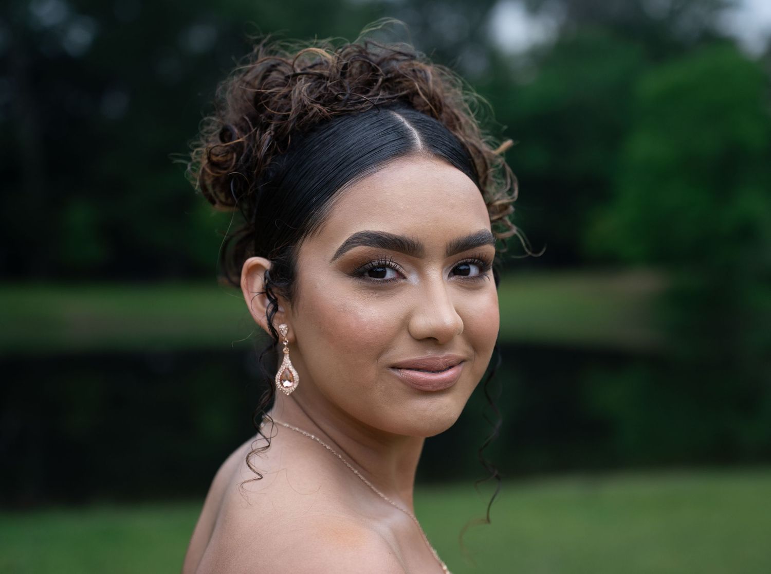 Series of elegant outdoor portrait poses against natural backdrop.