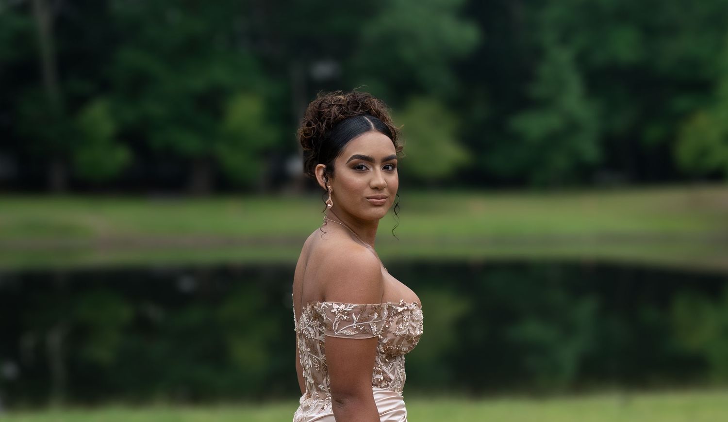 Outdoor portrait session in lush green garden setting.