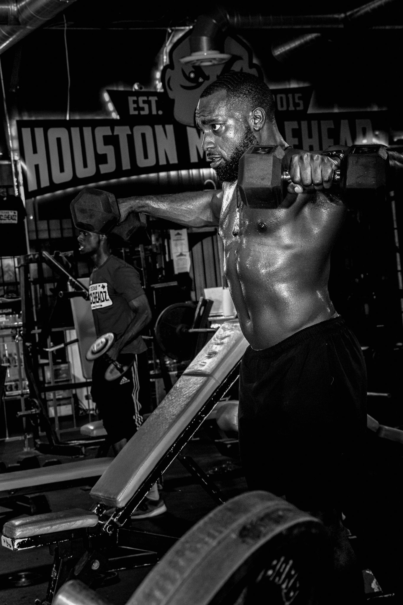 Intense workout session captured in black and white at Houston Muscle Heads gym.