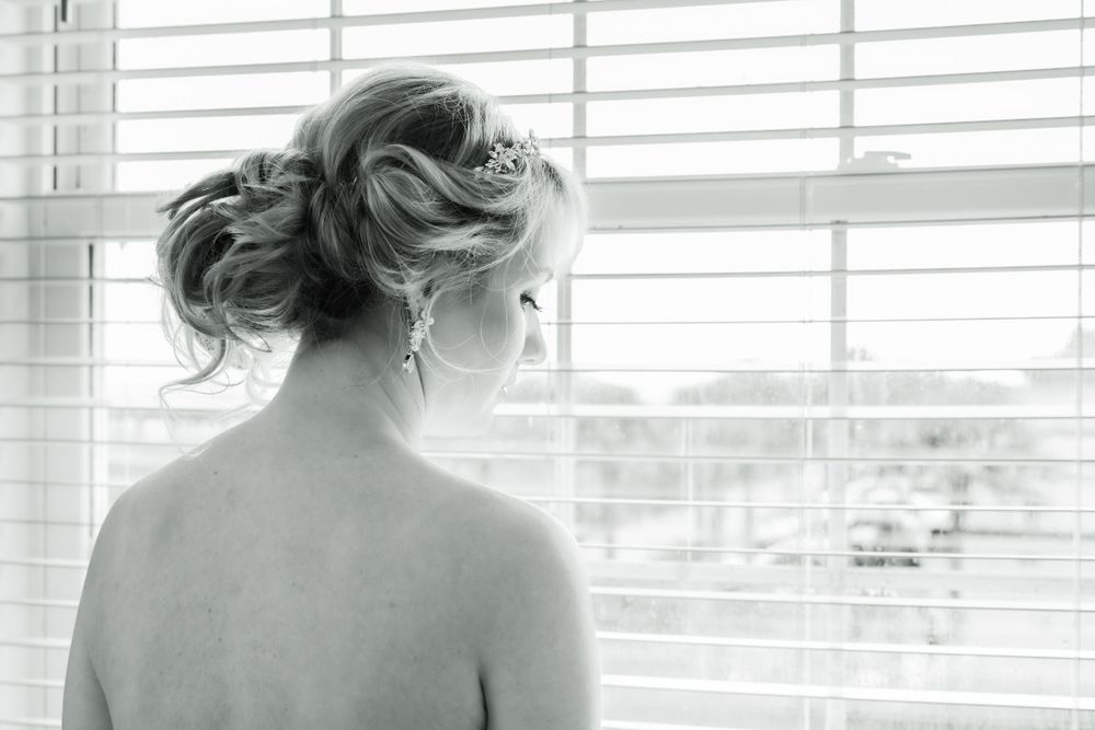 An artistic black and white portrait showing the back of a bride's hairstyle.