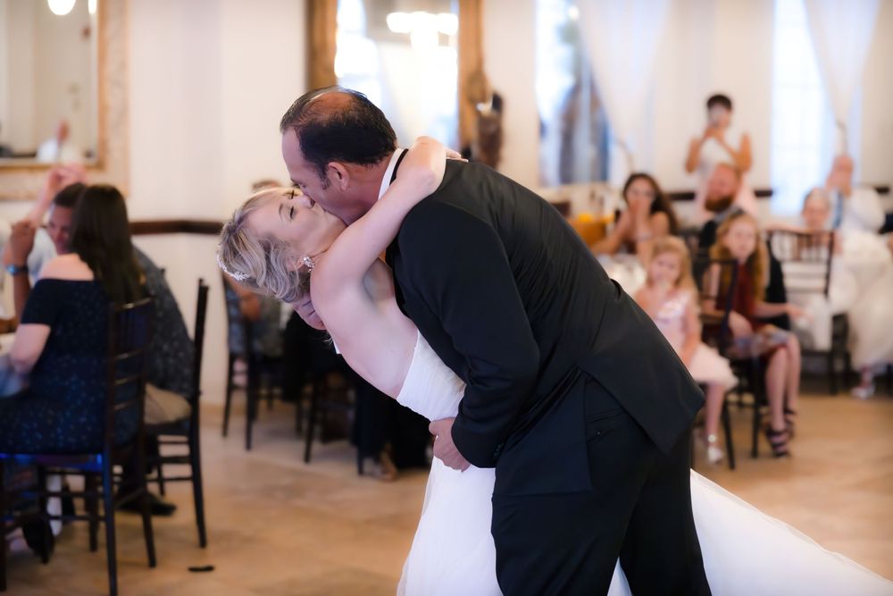 A wedding couple sharing their first dance in an elegant reception venue.