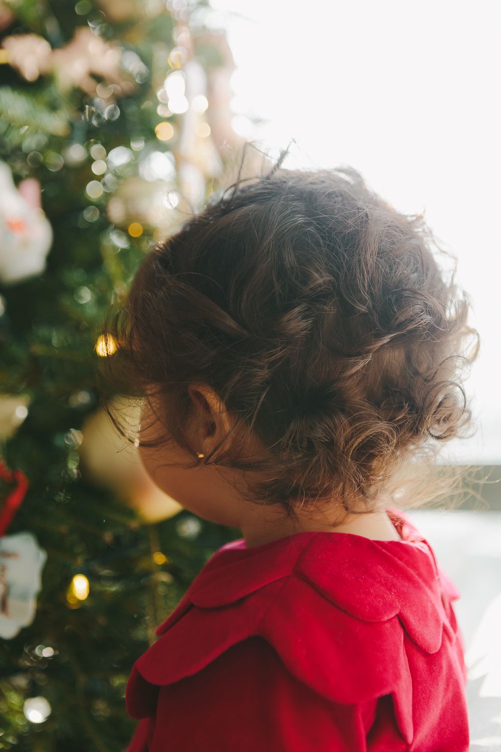 Christmas Delight: Toddler Girl's Joy in Front of the Tree - Paula Ortiz Photography