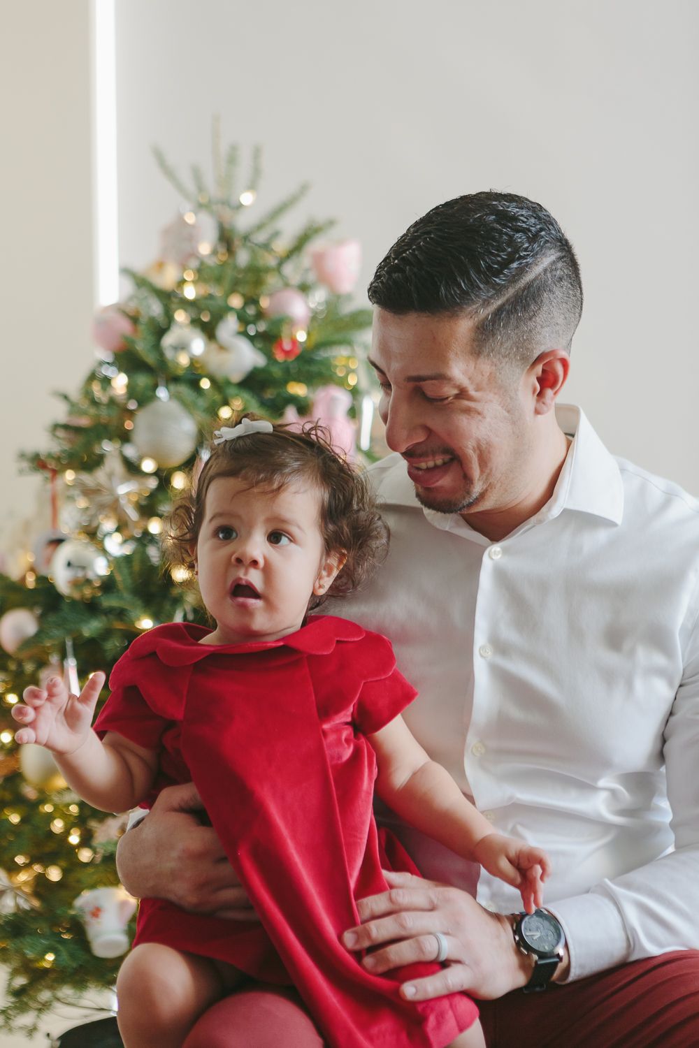 Festive Father-Daughter Bond: Dad and Girl by Christmas Tree - Paula Ortiz NYC Family Session