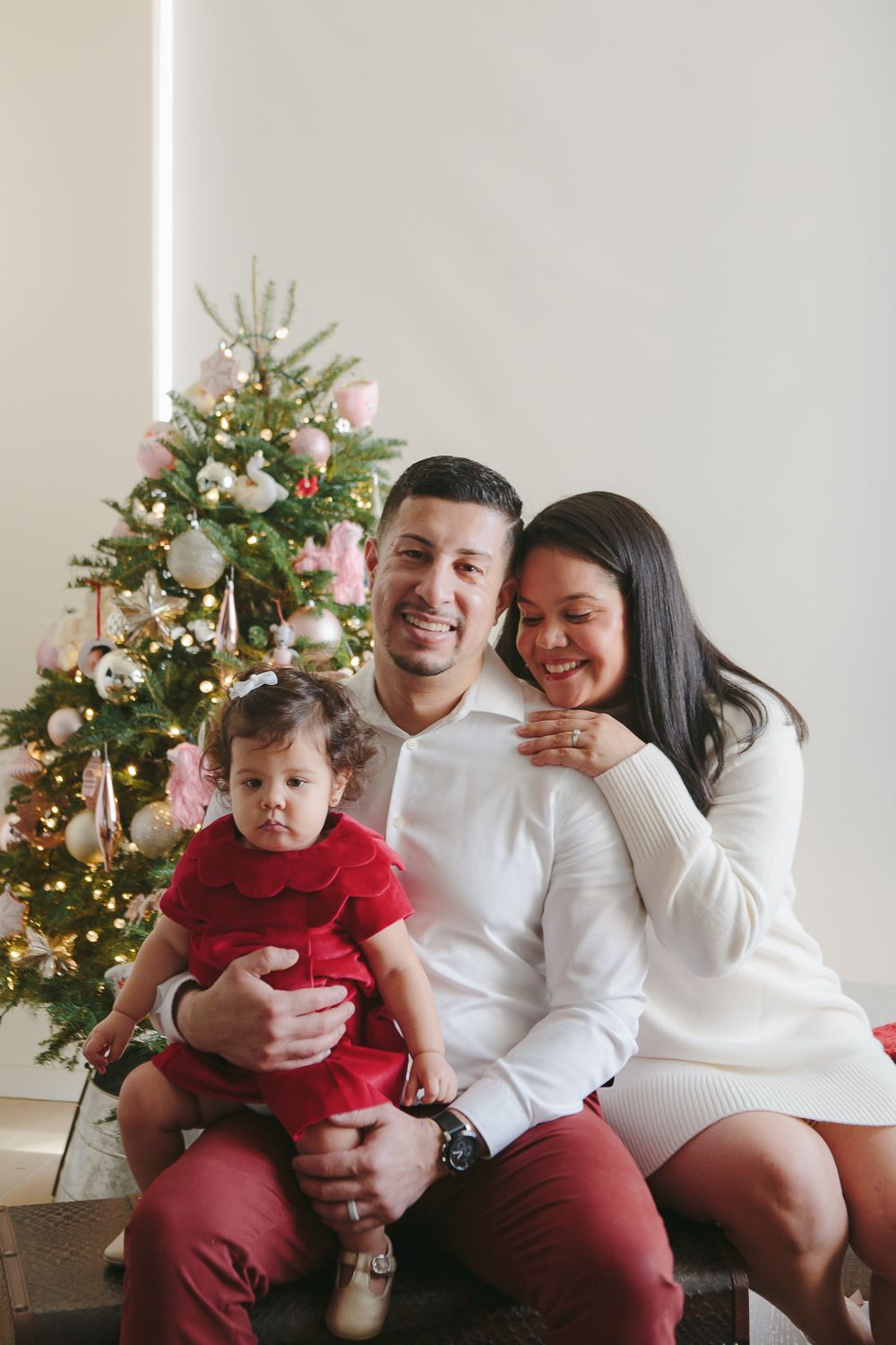 Cherished Family Time: Mom, Dad, and Daughter by the Christmas Tree - Paula Ortiz Photography