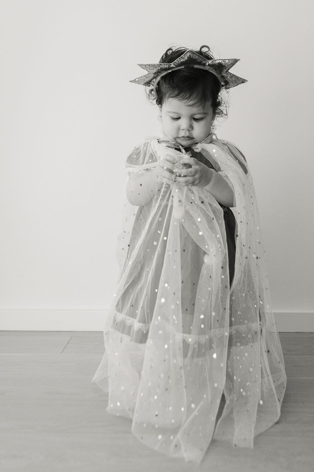 Festive Playtime: Girl in Cape and Star Band with Holiday Ornament - Paula Ortiz NYC Family Session