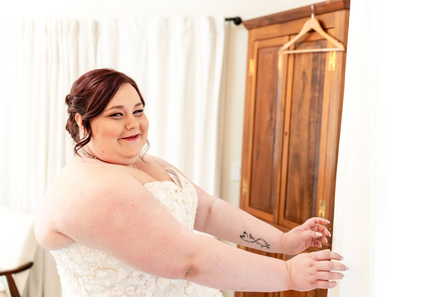 bride getting ready to open the curtain for a first look