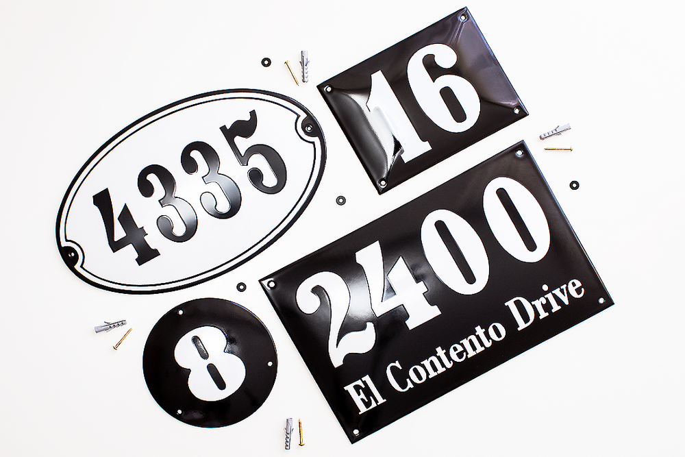 Black and white address numbers and street signs arranged on white background.