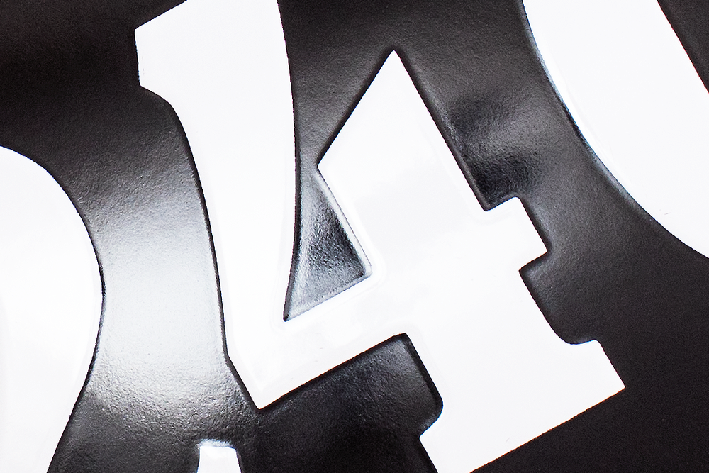 Extreme close-up of black numbers against white background showing bold typography.
