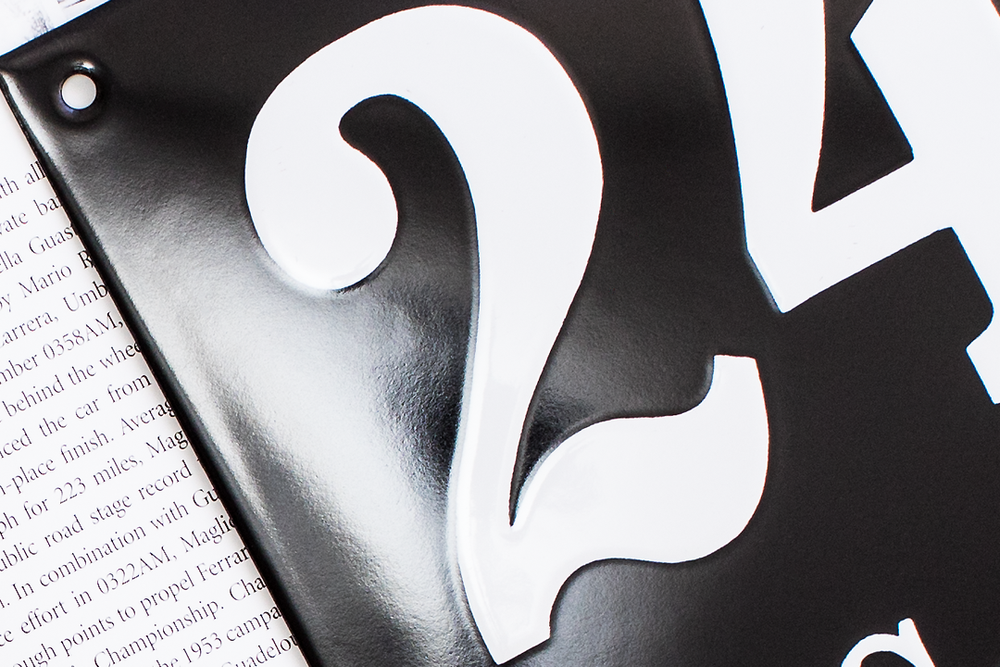 Macro shot of black number typography against white page background.