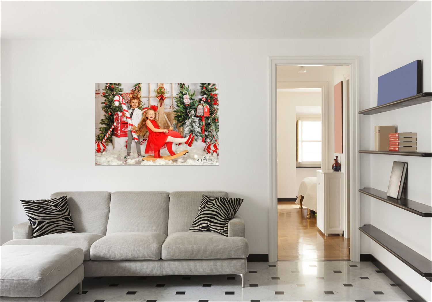 Living room with grey sectional sofa and red artwork displayed on white wall.