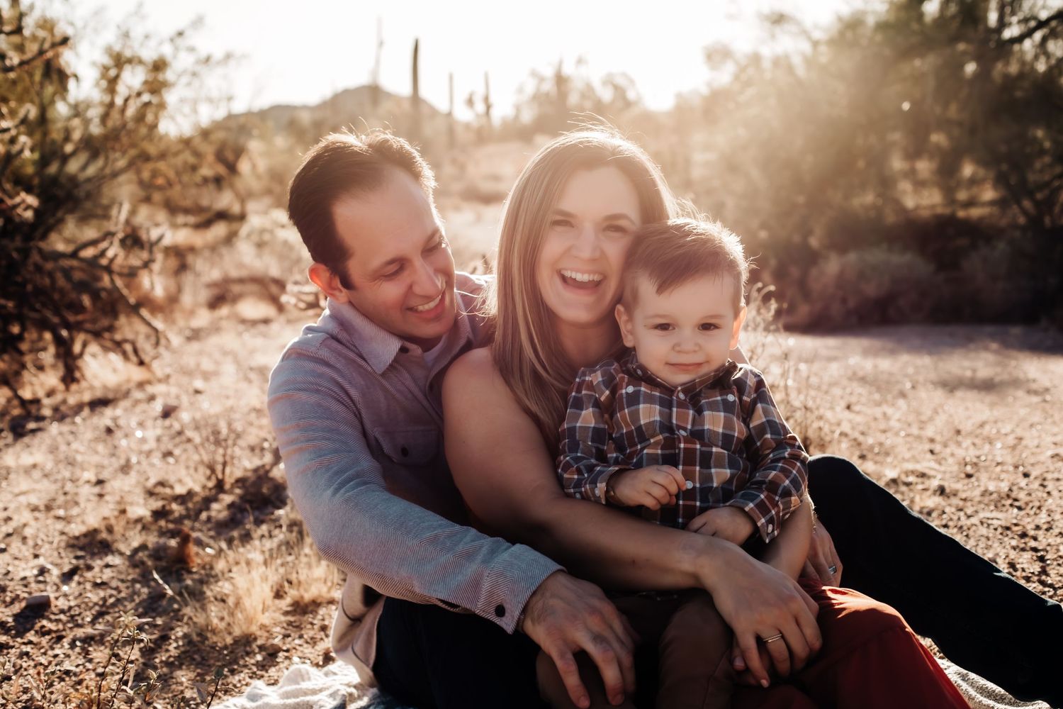 Family portrait series at sunset with warm golden lighting in desert setting.