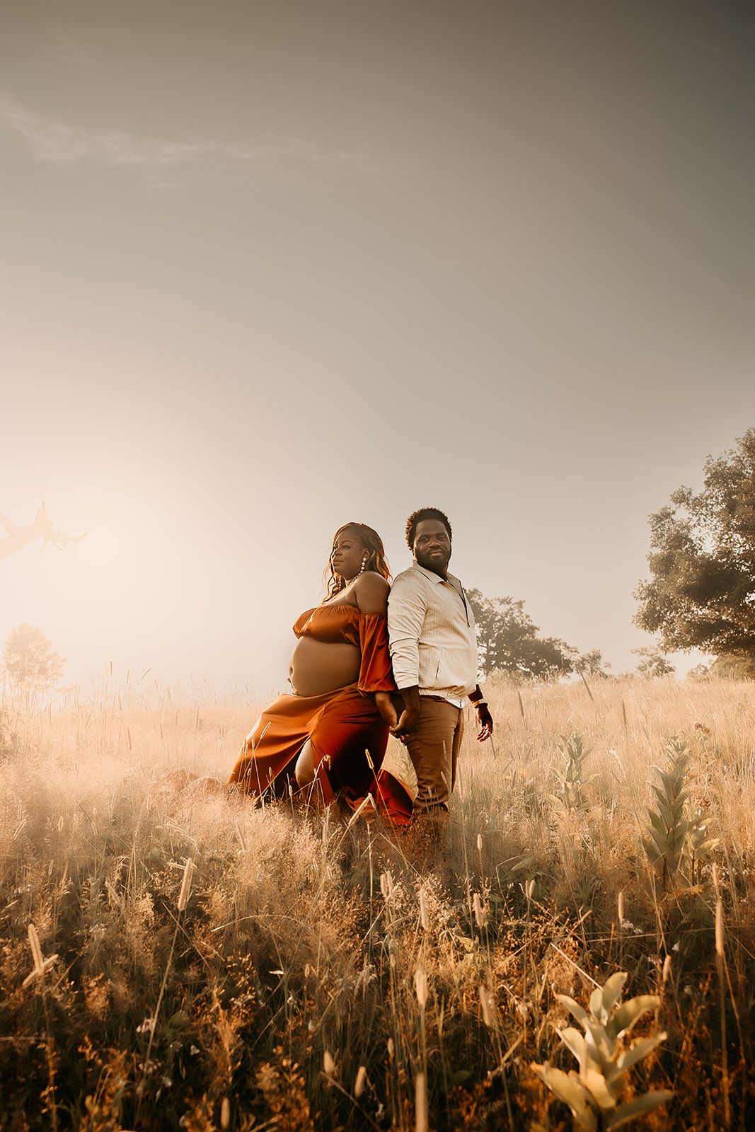 A couple stand back to back in Big Meadows for their maternity photoshoot.