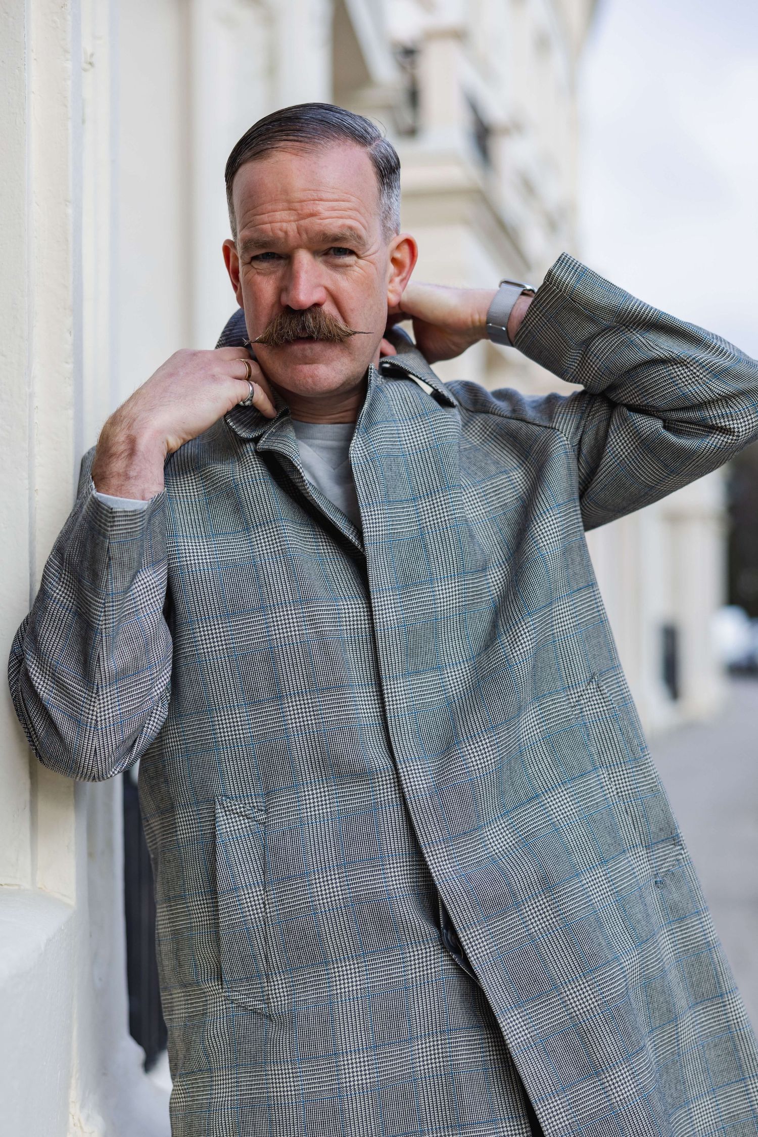 Dan fixing his collar looking cool for his portrait shoot in central Hove.