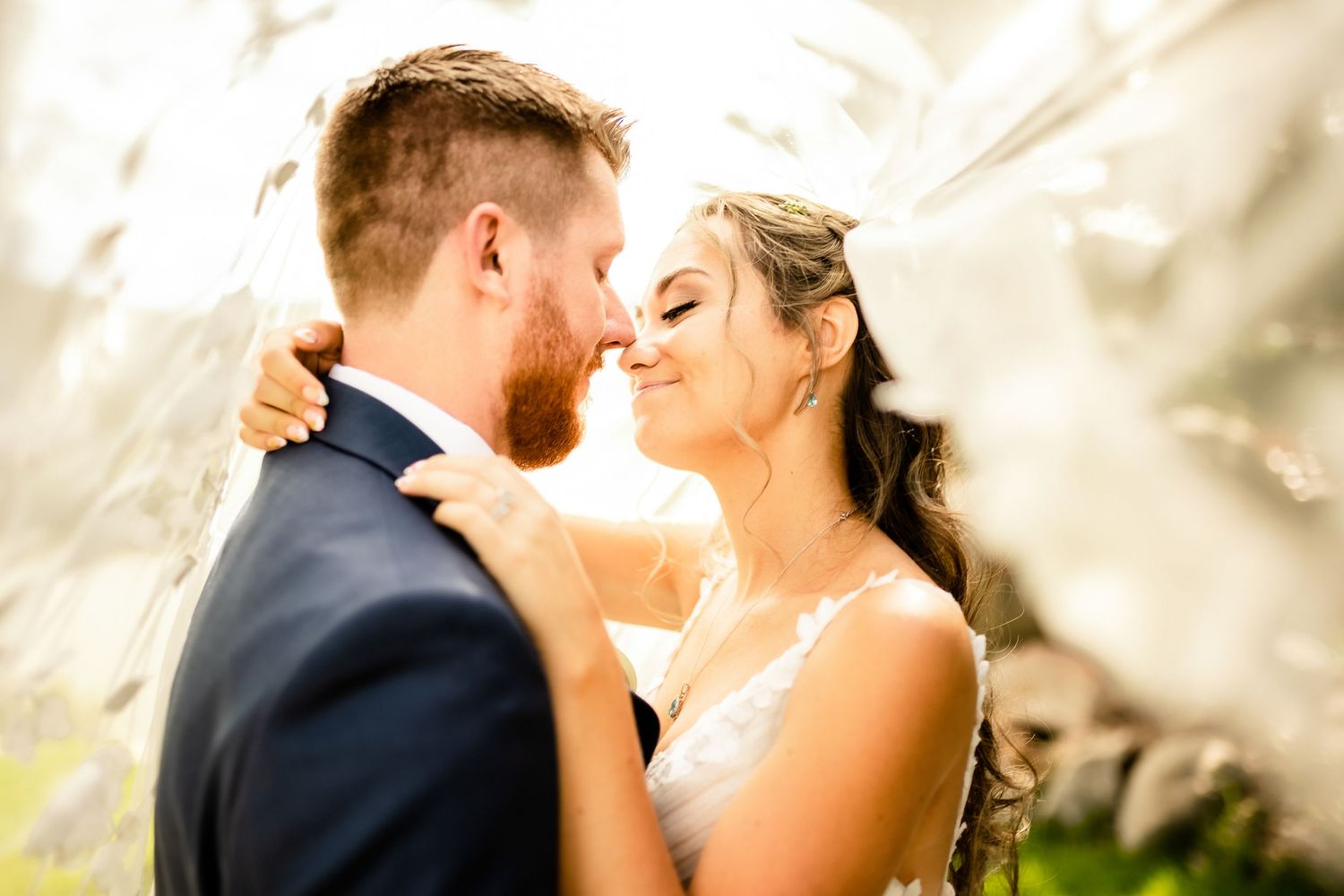 Romantic wedding couple portraits with soft golden lighting.
