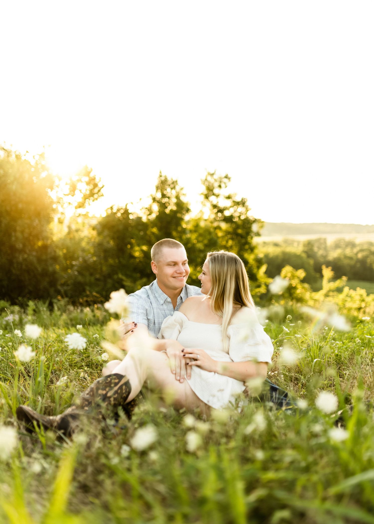 Romantic sunset photoshoot in a wildflower meadow with golden light.